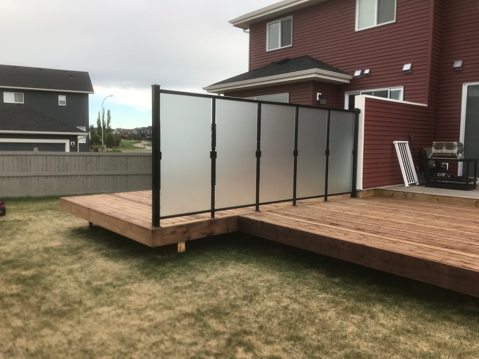 Aluminum frosted-glass privacy wall on a backyard deck in Edmonton