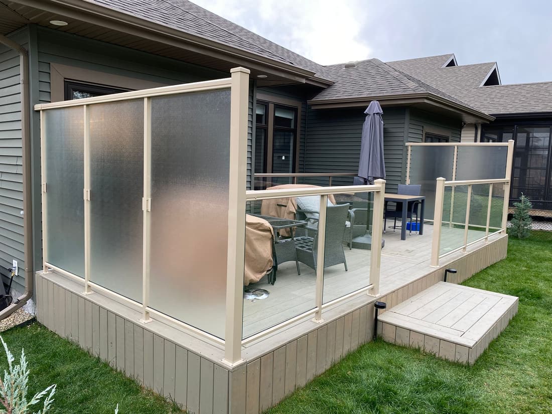 Aluminum-framed glass railing with frosted privacy panels on an Edmonton deck